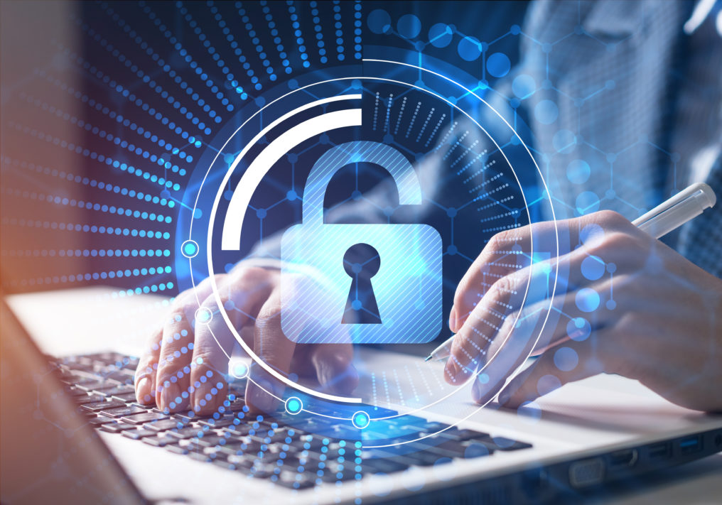 A person's hands typing on a laptop with an unlocked padlock icon in the foreground.